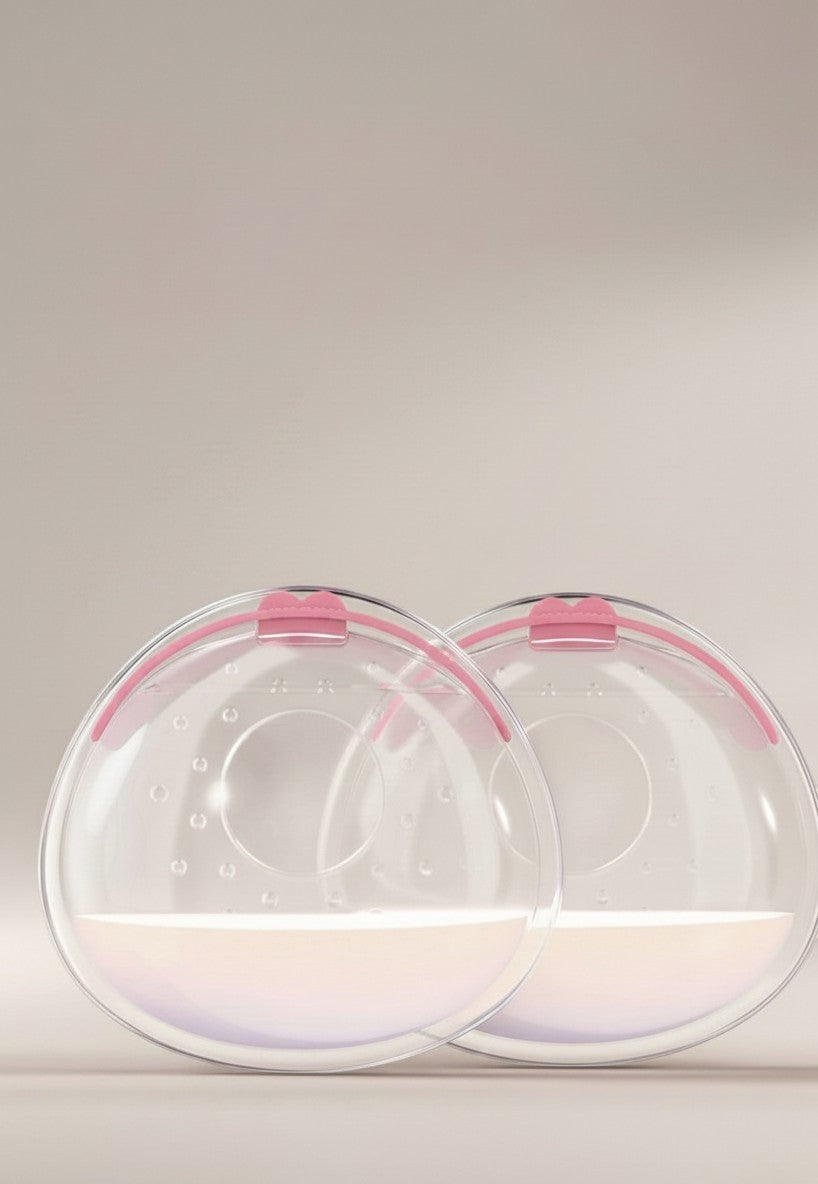 momviacare clear silicone breast milk collectors with pink trim, shown discreetly inside a bra and also as a pair.