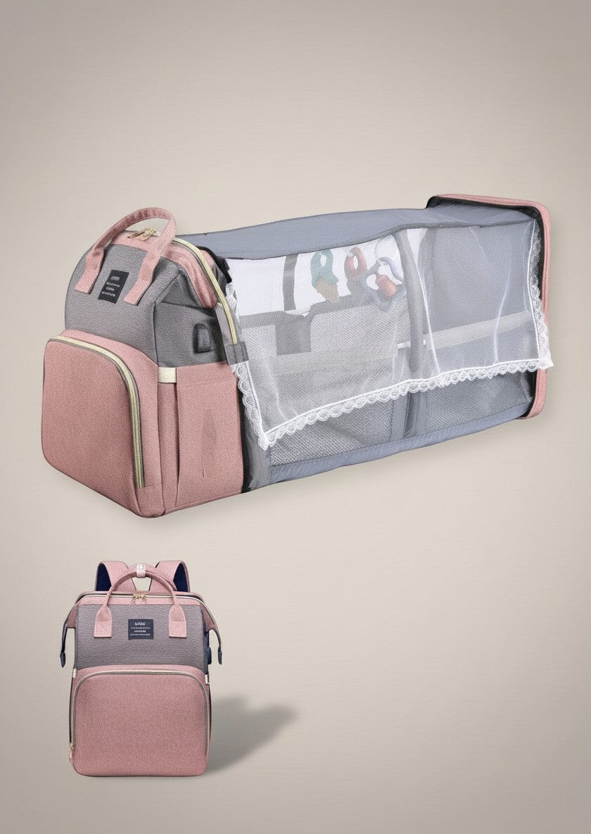 Momviacare grey and dusty rose convertible backpack bassinet with mesh sides and toys, ideal for travel.