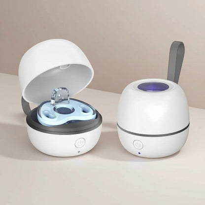 Momviacare portable white egg-shaped UV sterilizer case with a blue pacifier inside, open lid showing UV light.