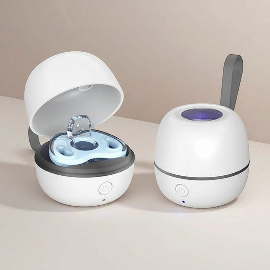 Momviacare portable white egg-shaped UV sterilizer case with a blue pacifier inside, open lid showing UV light.