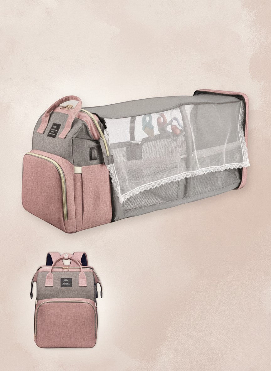 momviacare grey and dusty rose transformable backpack that unfolds into a bassinet with toy arch and changing station.